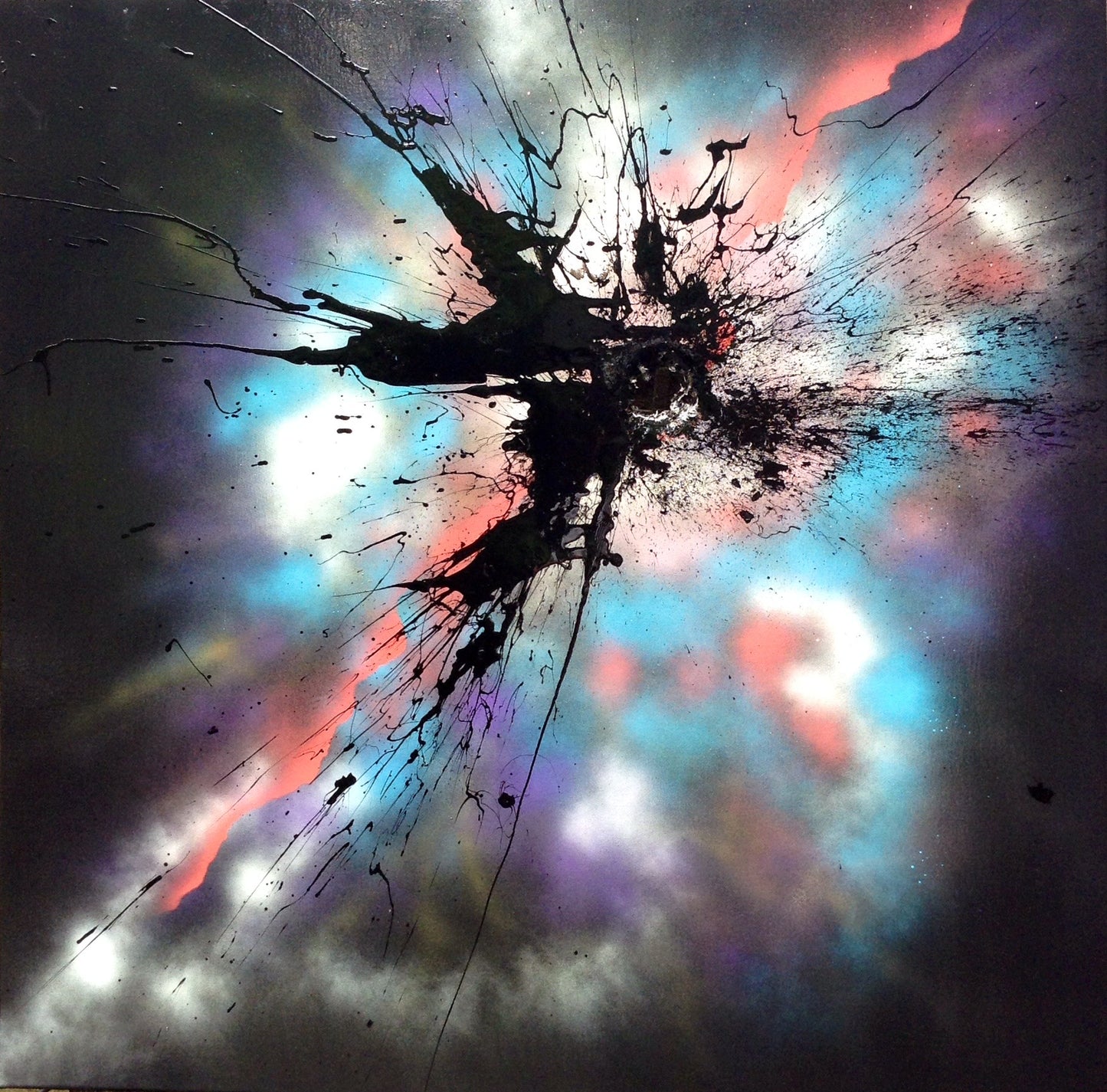 A black mak applied with a shotgun on a colourful sprayed background.
