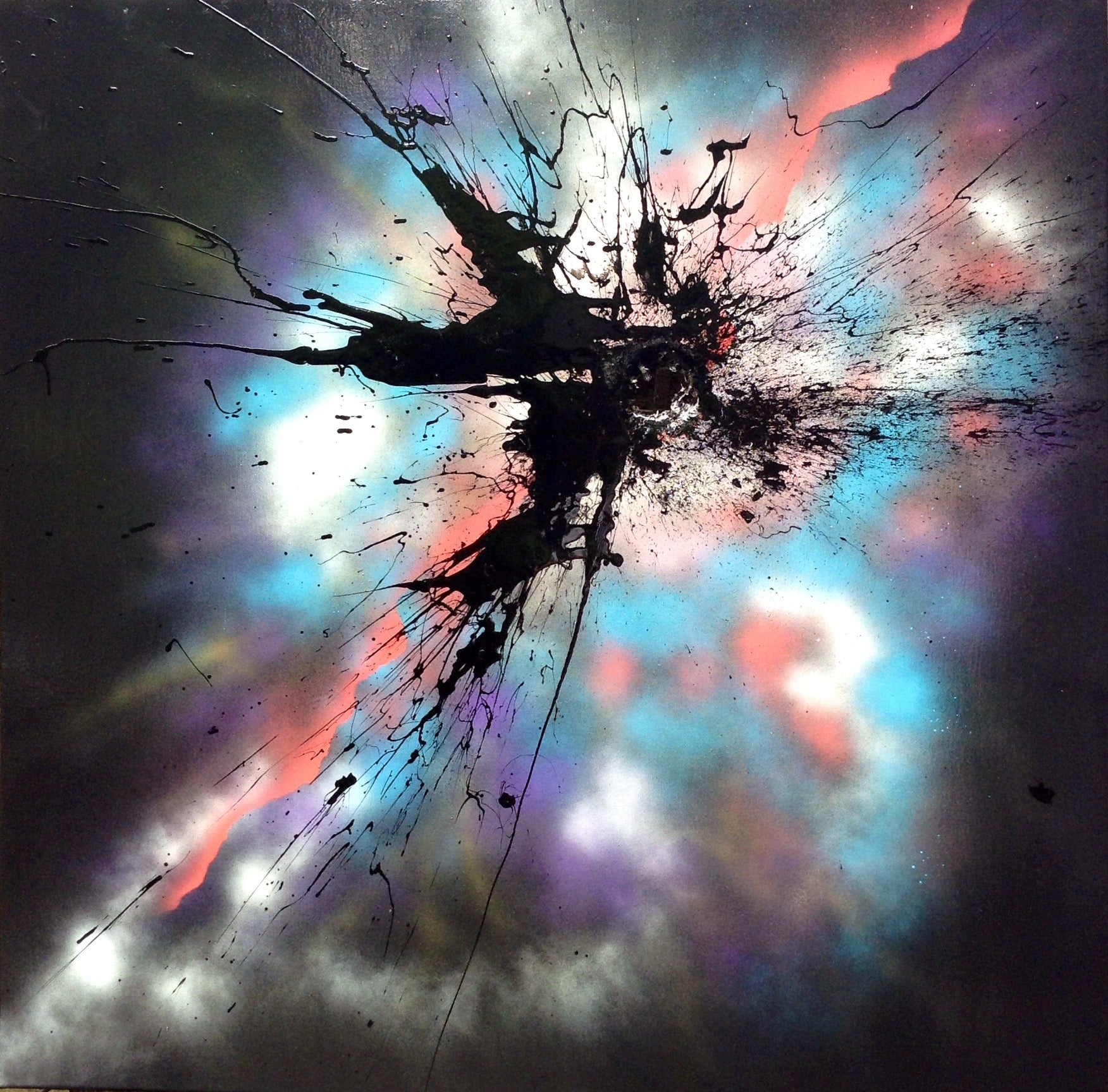 A black mak applied with a shotgun on a colourful sprayed background.