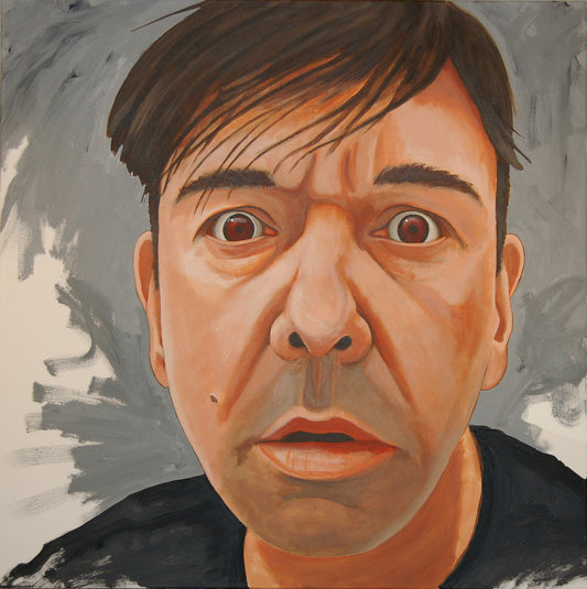 A self portrait looking intently at the viewer on a grey background.